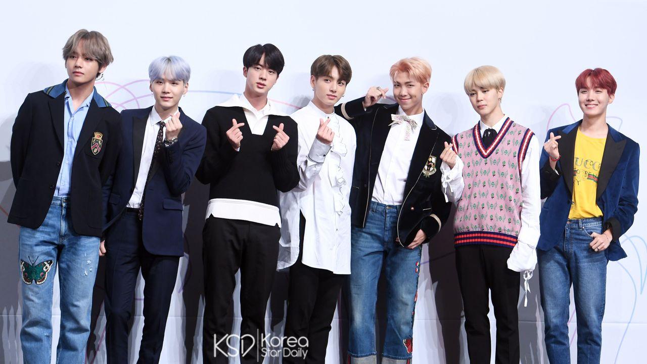 A popular Korean boy band BTS posing, emphasizing their influence in both South Korea and Japan.
